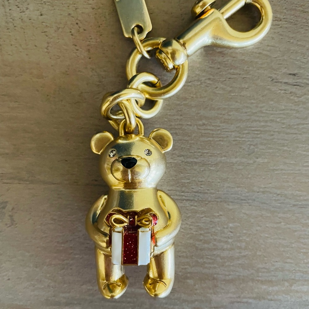 Coach Christmas bear charm holding a present